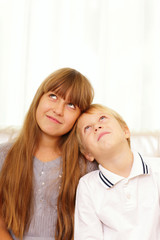 Brother and sister looking up at copyspace