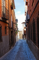 Fototapeta na wymiar Ancient narrow small street in Toledo, Spain
