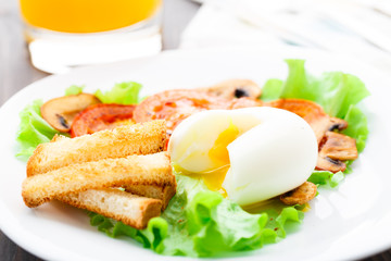 Light breakfast with soft egg, tomato and croutons
