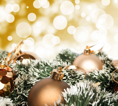 An arrangement of golden Christmas baubles against a festive bok