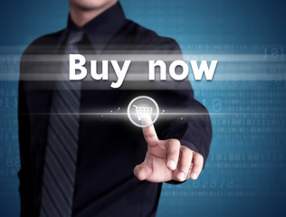 Business man pressing buy now on shopping cart icon