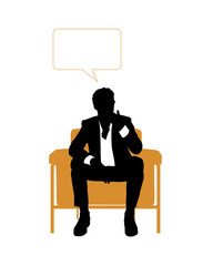 businessman seated in orange armchair and thinking