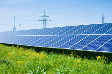 solar panel against high voltage towers