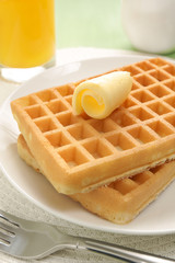 Waffle stack with a curl of butter and juice