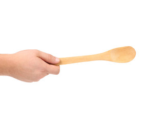 Hand holds wooden spoon