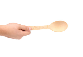 Hand holds wooden spoon
