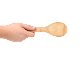 Hand holds wooden spoon