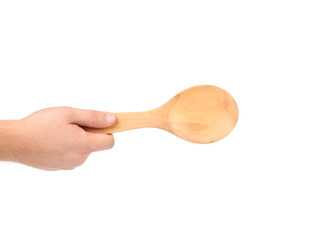 Hand holds wooden spoon