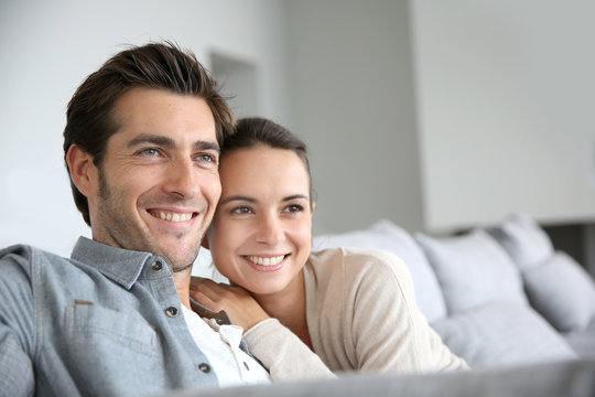 Couple at home relaxing in sofa