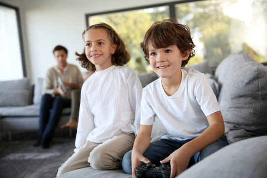 Kids at home playing video game