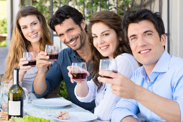 Friends Cheering With Wine Glasses