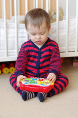 baby plays musical toy