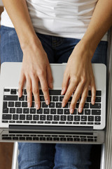 Fototapeta na wymiar Woman typing on laptop