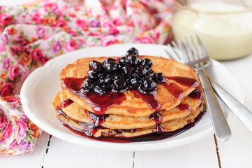 A Stack of Pumpkin Pancakes Topped with Chokeberry Preserves
