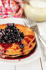 A Stack of Pumpkin Pancakes Topped with Chokeberry Preserves