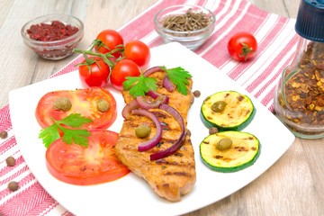 Grilled meat with vegetables and spices close up