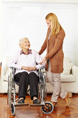 Seniorin im Rollstuhl bekommt Hausbesuch