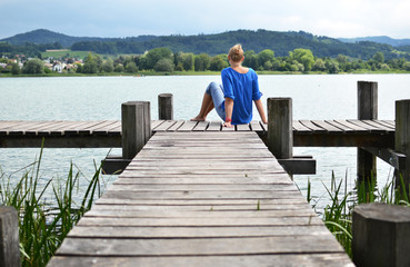 Girl on the wooden jetty. Switzerland