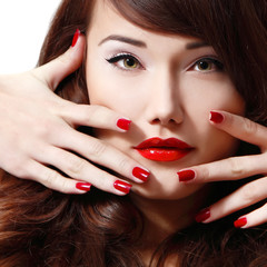 young woman portrait with long hair, red lipstick and manicure