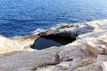 Fototapeta na wymiar rocky beach and natural pool in greece thassos