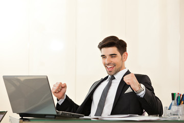business man smiling and celebrating a victory