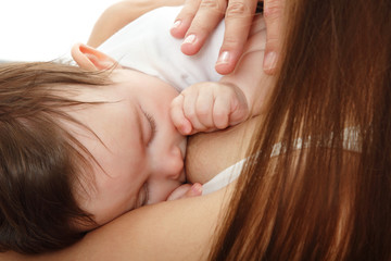 Obraz na płótnie Canvas young mother breast feeding her infant over white