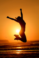 Happy woman jumping and sun