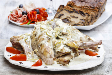 Rabbit in onion sauce on party table