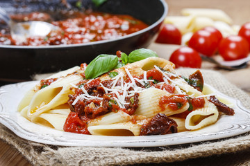 Penne with dried tomatoes. Italian cuisine, delicious, popular