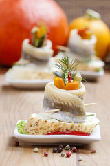 Pickled herring rolls with vegetables