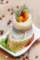 Pickled herring rolls with vegetables
