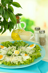 Delicious salad with eggs, cabbage and cucumbers on table