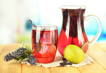 Red basil lemonade in jug and glass,