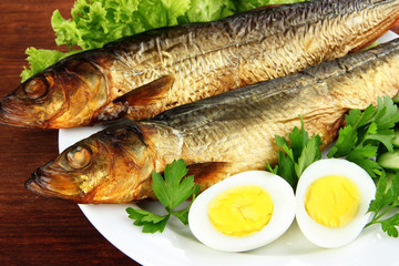 Smoked fish on plate close up