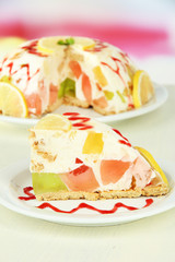 Delicious jelly cake on table on light background