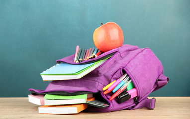 Purple backpack with school supplies