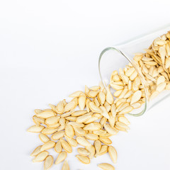 Pumpkin seed in glass isolated on white background