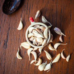 close up of garlic in cup on wood