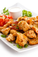 Grilled meat and vegetables on white background