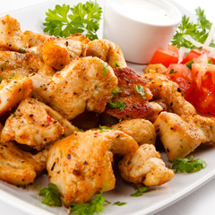 Grilled meat and vegetables on white background