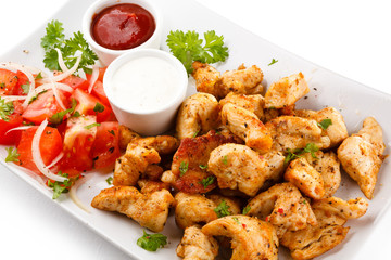 Grilled meat and vegetables on white background