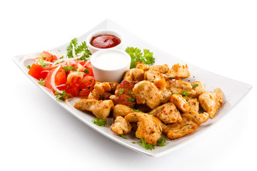 Grilled meat and vegetables on white background