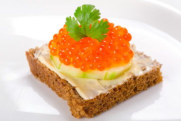 Sandwich with red caviar on the plate