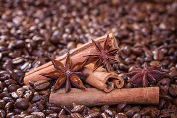 Cinnamon sticks and star anise on a background of coffee beans