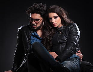 embraced seated couple in leather jackets