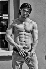 Fototapeta na wymiar Muscular young bodybuilder shirtless outdoors