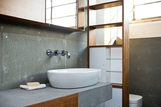 Detail of bathroom in rough concrete grey style