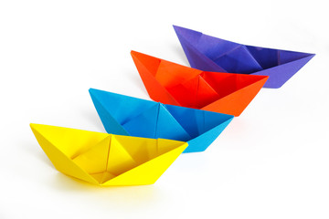 Four colored paper ship on a white background