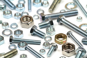 Close up various bolts, nuts, and washers on white background.