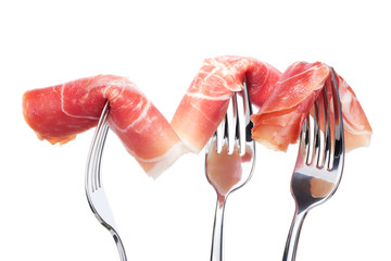Spanish jamon on forks isolated